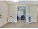 Hallway featuring gray wood-look tile floors leading to office/bedroom at 268 Ibiza Loop, Venice, FL 34292