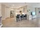 Open-concept kitchen features stainless steel appliances and a breakfast bar at 268 Ibiza Loop, Venice, FL 34292