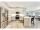 Bright kitchen with stainless appliances, a breakfast bar and open to living area at 268 Ibiza Loop, Venice, FL 34292