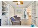 Well-lit office with white furniture, stylish ceiling fan, and glass door at 268 Ibiza Loop, Venice, FL 34292