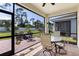 Inviting screened-in patio with brick flooring and an outdoor dining set for relaxing or entertaining at 268 Ibiza Loop, Venice, FL 34292