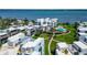 Aerial view showcases condos with a pool, gardens, and bay views at 2955 N Beach Rd # A422, Englewood, FL 34223