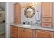 Bathroom featuring a wood vanity, granite countertops, accent lighting and plenty of storage at 2955 N Beach Rd # A422, Englewood, FL 34223