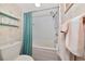 Full bathroom with shower-tub combo featuring a teal curtain and coordinating accessories at 2955 N Beach Rd # A422, Englewood, FL 34223
