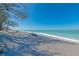 Beautiful sandy beach with clear water and people enjoying sunny day in beach chairs at 2955 N Beach Rd # A422, Englewood, FL 34223