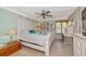 Primary bedroom featuring a large bed, ceiling fan, and tile flooring with decorative accents and modern finishings at 2955 N Beach Rd # A422, Englewood, FL 34223