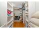 Walk-in closet with built-in shelving and wood flooring providing ample storage and organization options at 2955 N Beach Rd # A422, Englewood, FL 34223