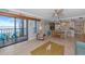 Open-concept living and dining room with tile floors and access to the screened-in porch at 2955 N Beach Rd # A422, Englewood, FL 34223
