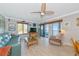 Comfortable living room with water views, tile floors, ceiling fan, and access to the screened-in porch at 2955 N Beach Rd # A422, Englewood, FL 34223