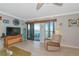 Bright living room with a view to the balcony and coastal decor at 2955 N Beach Rd # A422, Englewood, FL 34223