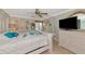 Spacious main bedroom with tile floors, large bed, flat screen TV, and ceiling fan at 2955 N Beach Rd # A422, Englewood, FL 34223