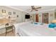 Light and bright main bedroom includes a desk and bed with white furniture and blue floral pattern at 2955 N Beach Rd # A422, Englewood, FL 34223
