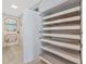 A white pantry featuring several pull out shelves provides ample storage space in this home at 2955 N Beach Rd # A422, Englewood, FL 34223