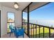This screened-in porch features an open-air view of the water with seating for relaxation at 2955 N Beach Rd # A422, Englewood, FL 34223