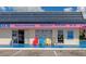 Charming beach souvenir shop, open 9-7, with colorful chairs outside the storefront at 2955 N Beach Rd # A422, Englewood, FL 34223