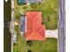 Aerial view of home showcasing tile roof, landscaping, and waterfront access at 322 Oakwood Cir, Englewood, FL 34223
