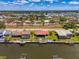 Waterfront homes along a canal feature boat docks and lush landscaping in this aerial community view at 322 Oakwood Cir, Englewood, FL 34223