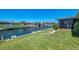 Beautiful backyard with lush green grass, private dock, and canal views at 322 Oakwood Cir, Englewood, FL 34223