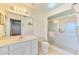 Clean bathroom with tiled floor, glass door shower, and a sleek vanity at 322 Oakwood Cir, Englewood, FL 34223