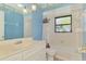 Bathroom with blue walls and a decorative lighthouse theme at 322 Oakwood Cir, Englewood, FL 34223