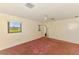 Bedroom features plush pink carpet, a ceiling fan, and bright windows at 322 Oakwood Cir, Englewood, FL 34223