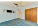 Bedroom with ceiling fan, closet, and a TV mounted on the wall at 322 Oakwood Cir, Englewood, FL 34223