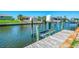 This dock shows a canal with a boat lift along a scenic waterway, perfect for boating enthusiasts at 322 Oakwood Cir, Englewood, FL 34223