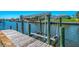 Private dock with boat lift on a sunny day at 322 Oakwood Cir, Englewood, FL 34223