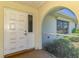 A welcoming entryway with a decorative front door, a tiled porch, and a glimpse of the exterior at 322 Oakwood Cir, Englewood, FL 34223