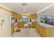 Bright eat-in kitchen with generous cabinets, tile floors, and a breakfast island with seating at 322 Oakwood Cir, Englewood, FL 34223