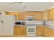 Kitchen with classic cabinets and modern appliances at 322 Oakwood Cir, Englewood, FL 34223