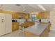 Eat-in kitchen with ample counter space, classic cabinetry, and modern appliances at 322 Oakwood Cir, Englewood, FL 34223