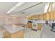 Functional kitchen features classic cabinetry, an island, and an adjacent seating area at 322 Oakwood Cir, Englewood, FL 34223