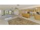 Spacious open concept home with combined living, dining, and kitchen areas, tile floors, and lots of light at 322 Oakwood Cir, Englewood, FL 34223