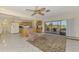 Open-concept living area with a kitchen, tiled floor, and sliding glass doors to the lanai at 322 Oakwood Cir, Englewood, FL 34223