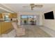 Bright living room with tile floors, a view of the lanai, and an open kitchen at 322 Oakwood Cir, Englewood, FL 34223