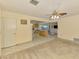 Spacious living room adjacent to the open concept kitchen, featuring carpeted floors at 322 Oakwood Cir, Englewood, FL 34223