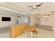 Open-concept living space features tile floors, an island, and neutral wall colors at 322 Oakwood Cir, Englewood, FL 34223