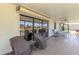 Spacious covered patio with tiled floors, roll-down shutters, ceiling fan, and views of the canal at 322 Oakwood Cir, Englewood, FL 34223