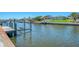 Picturesque waterfront view with boat dock and lush landscaping at 322 Oakwood Cir, Englewood, FL 34223