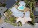 An aerial view of a charming home with a sparkling pool, a driveway, and lush landscaping at 337 Harbor S Dr, Venice, FL 34285