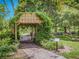 A beautiful view of Monty Andrews Arboretum showcasing lush greenery, a brick pathway, and inviting picnic tables at 337 Harbor S Dr, Venice, FL 34285