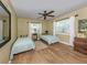 Bright bedroom with hardwood floors, ceiling fan and two windows, perfect for guests at 337 Harbor S Dr, Venice, FL 34285