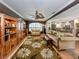 Inviting living room with decorative rug, built-in shelving, and view of the adjacent open kitchen at 337 Harbor S Dr, Venice, FL 34285