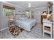 Comfortable main bedroom featuring neutral decor, a ceiling fan, and ample natural light at 337 Harbor S Dr, Venice, FL 34285