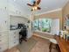Functional home office with custom cabinetry, a ceiling fan, and a large window with bright, natural light at 337 Harbor S Dr, Venice, FL 34285