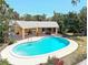 Backyard oasis featuring a sparkling blue pool with a covered outdoor lounge area and lush foliage at 337 Harbor S Dr, Venice, FL 34285