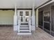 Welcoming back porch featuring a covered area with pillars and an enclosed porch for relaxing at 379 Harbor Isles Dr, North Port, FL 34287