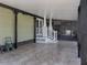 Spacious back porch with covered area, tiled flooring and charming white pillars leading to backyard at 379 Harbor Isles Dr, North Port, FL 34287