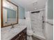 Bathroom with a marble vanity, a tiled shower, and decorative wainscotting at 379 Harbor Isles Dr, North Port, FL 34287